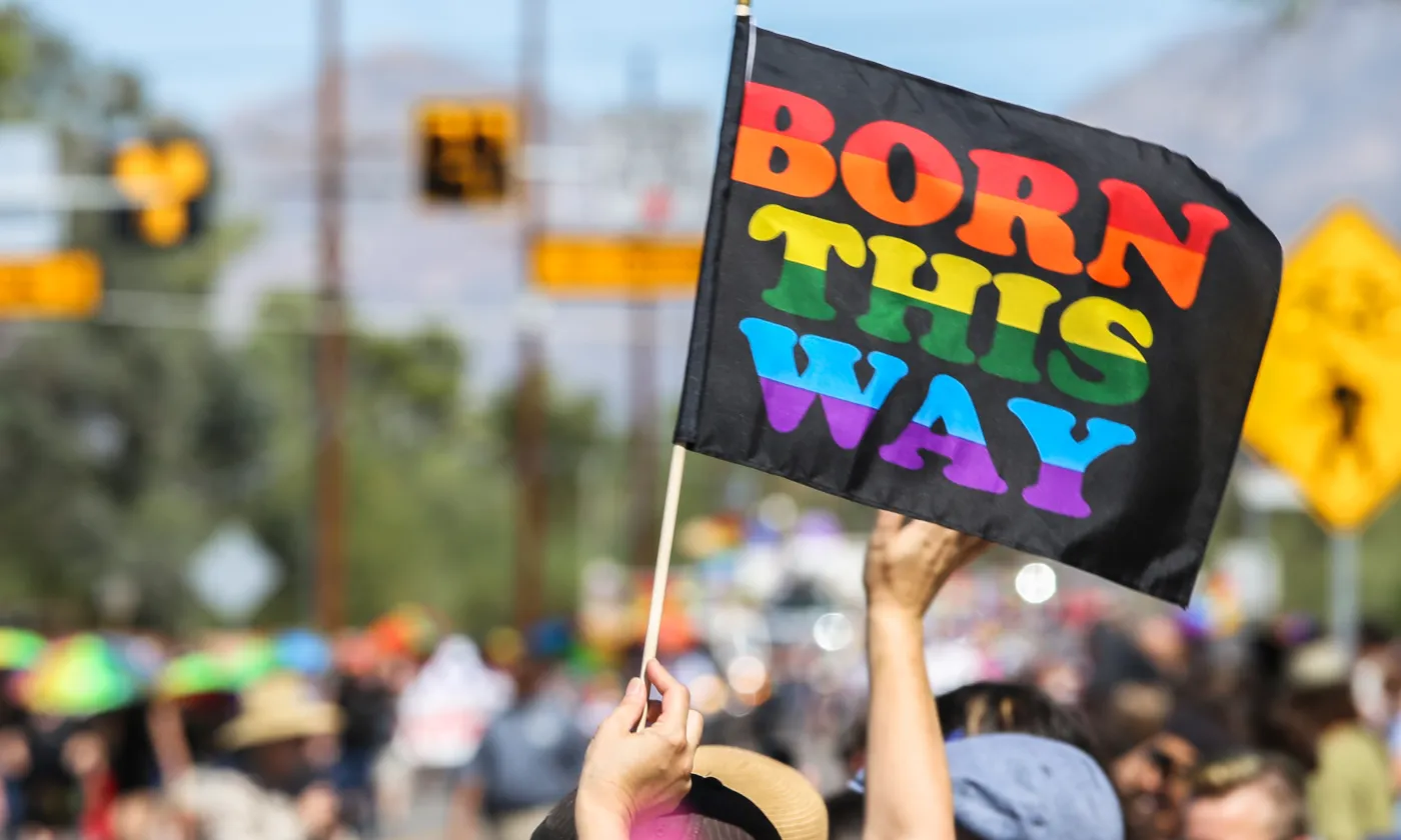 LGBT Pride flag reading Born This Way in rainbow colors at a Pride Parade Photo by Chance Agrella from Freerange Stock