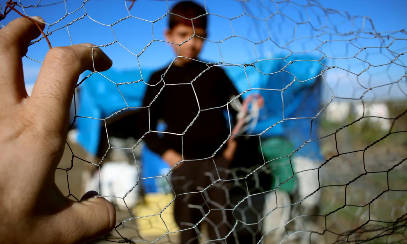 Un jeune migrant derrière une clôture. Image prétexte. ©cloverphoto / iStock